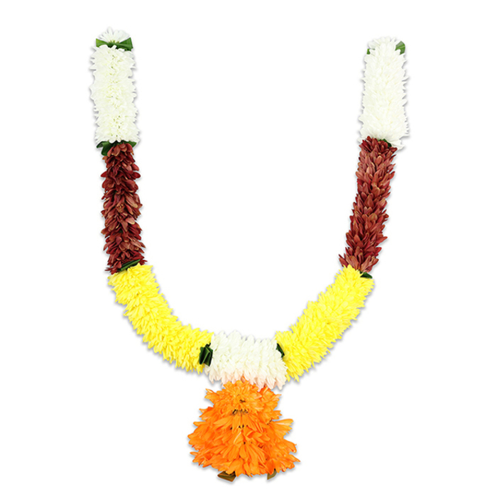 This U-shaped decorative mala hangs like a promise of celebration, captured on a plain white field so every colour reads clearly. The very top of each arm begins with compact, creamy-white florets - delicate, cushiony clusters that recall small chrysanthemums and lend a luminous, reverent crest to the garland. Directly beneath, a strong band of reddish-brown elements provides a dense, textured counterpoint; their flattened, layered appearance suggests dried petals or woody buds and brings an earthy solidity that steadies the design. As the arms curve down, the composition blossoms into a broad sweep of radiant yellow - plush, marigold-like tufts densely strung to form the main visually warm U-shape that signals auspiciousness in Indian tradition. At the lowest point a generous pendant drops: a multilayered, vivid orange pom-pom whose ruffled petals create a rich, rounded focal ornament evocative of celebratory marigolds. Scattered flashes of bright green mark the joins between colour segments, working like tiny leaves or ribbon breaks that add rhythm and lift. The garland is artificial but carefully assembled to mimic natural depth and volume; soft studio light reveals a slight sheen on the fibres and suggests a gentle, almost nostalgic scent memory rather than true fragrance. As a Stanmore florist I imagine this hung above the door of a family home on Stanmore Broadway or used to frame a puja alcove near Bentley Priory; Flowers Stanmore would craft such a piece for festivals like Diwali, Ganesh Chaturthi, weddings or as enduring doorway decor for local events.