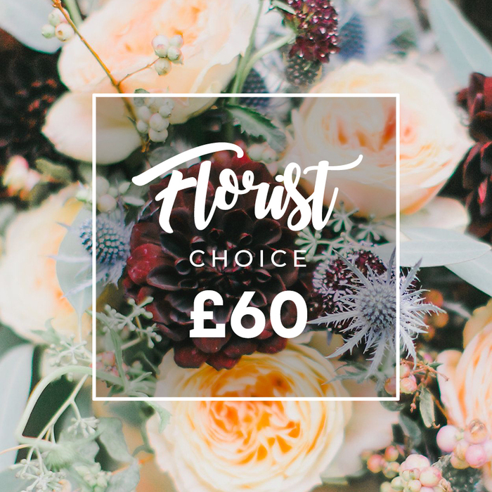 This intimate photograph captures a bouquet arranged with an eye for texture and quiet drama: at its heart sits a striking, dark burgundy dahlia whose velvet-like petals form concentric layers, surrounded by garden roses in creamy white, soft peach and blushing apricot that spill open in soft, romantic rosettes. Sprigs of silver-blue eryngium (sea holly) thrust through the softness with an angular, almost architectural texture, and pale green-to-white berries provide small, glossy accents that catch the light. Eucalyptus leaves and an assortment of leafy greens-some cool and frosted, others deep and glossy-frame the flowers and give the composition a garden-fresh silhouette. The lighting is gentle and natural, emphasizing petal translucence and the tactile contrast between silky roses and spiky thistles. Superimposed on the image is a minimal white frame with rounded corners: inside, the word Florist appears in an elegant script, CHOICE in a tidy uppercase sans-serif, and the clear, bold price £60 anchors the layout. The bouquet reads as both celebratory and consoling-equally suited to a wedding table, a birthday gesture, or a sympathetic delivery-and it evokes the kind of blooms our customers often request for homes and events near Stanmore Station and the quieter lanes around Harrow, where seasonal ingredients and calm craftsmanship matter.