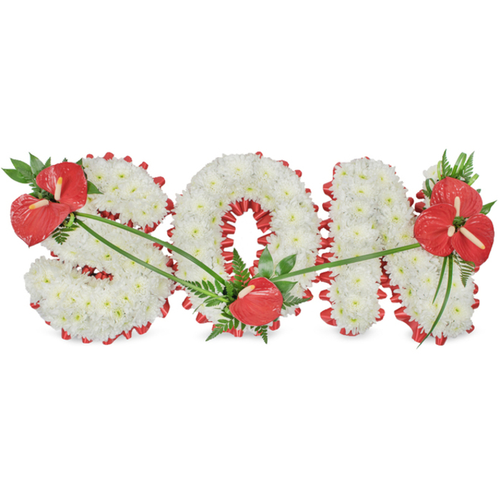 This photograph shows a personalised funeral flower arrangement spelling out the word SON in prominent, three-dimensional capital letters, positioned against a pure white background so the design appears clean and uncluttered. Each letter is densely covered with pure white chrysanthemums, their compact, petal-filled blooms placed so closely together that no gaps appear, creating a soft, velvety texture reminiscent of freshly fallen snow. Framing the base and edges of the S, O, and N is a richly coloured red satin ribbon, carefully gathered into a ruffled, scalloped trim. The ribbon hugs the contours of the lettering, adding definition and a warm contrast that symbolises love and heartfelt remembrance. Three distinct groupings of red anthuriums bring dramatic highlights to the arrangement. These anthuriums, with their glossy, heart-shaped spathes and upright, central spadices, are set among dark green leaves and fine, feathery foliage. A full, eye-catching spray sits on the upper left side of the S, tilting gently across the letter as if offering a protective gesture. At the lower curve of the O, a single anthurium is carefully nestled among the chrysanthemums, adding a delicate accent at the heart of the tribute. The final and most substantial cluster sits proudly on the upper right of the N, with several anthuriums and lush greenery forming a beautifully balanced end to the word. Fine, elongated green leaves sweep across the letters, weaving the red groups together visually. Arrangements like this, often created by Flowers Stanmore for services at local chapels and crematoria, provide families with a meaningful way to honour and remember a cherished son in a setting of quiet elegance.