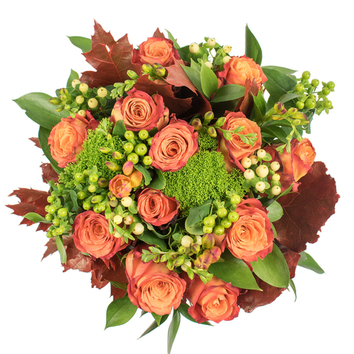 Captured in a bird's-eye view on a pristine white surface, this richly textured floral composition celebrates the deep, warm tones of autumn with careful, layered artistry. The central narrative is told by a profusion of fully opened roses whose petals move from a soft peach core into coral and then into deeper orange and rust at the margins, creating a multidimensional, fall-like gradient. Interspersed among these classic blooms are tufts of Green Trick dianthus-rounded, plush, lime-green mounds that read as miniature cushions of moss and introduce an unexpected tactile note. Groupings of Hypericum berries-some brightly lime, others a pale creamy-yellow-dot the bouquet like light-reflecting beads, adding small luminous accents and a crisp contrast to the warm roses. Rich, lobed foliage in shades of burgundy and reddish-brown is strategically placed to evoke fallen leaves, offering a rustic depth that anchors the arrangement and reinforces the seasonal theme. Varied fresh greenery fills the spaces in between, from broad glossy leaves that catch the light to finer textured stems that add movement and volume. Under a soft, diffused light, velvety petals, waxy berries, and mossy dianthus reveal layer after layer of texture and scent-a gentle rose perfume blended with a faint, earthy mossiness. This piece feels ideal for autumnal occasions: a Thanksgiving table centre, a cosy home accent, or a thoughtful seasonal gift for neighbours or friends near Stanmore Common, evoking warmth, harvest comfort, and the quiet beauty of fall.