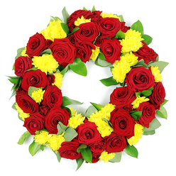 This image features a beautifully composed circular wreath, carefully laid out against a pure white background so that every bloom and leaf can be clearly seen. The wreath is created from a generous mix of deep red roses and bright yellow chrysanthemums, packed closely together to form a lush, unbroken ring of colour. The roses are fully open, their velvety petals overlapping in tight spirals that range from classic crimson to deeper burgundy, evoking feelings of devotion, respect, and heartfelt farewell. Interspersed throughout, small clusters of yellow chrysanthemum blooms add brightness, their many fine, feathery petals forming rounded cushions that lend a soft, comforting texture. Supporting the flowers is a base of rich green foliage, including broad, glossy leaves and more muted, grey-green stems, likely eucalyptus or similar, which introduce both structure and a hint of woodland freshness. The symmetry of the circle, with its clear central opening, reflects thoughtful craftsmanship, like something created in a Stanmore flower shop just off the high street before being delivered to a nearby chapel or cemetery. The lighting is bright and even, enhancing the intensity of the colours and the subtle variations in petal and leaf textures. The overall mood of the piece is dignified yet warm, a fitting funeral or memorial wreath for services in and around Stanmore, offering comfort and a visible expression of enduring love and remembrance for the person being honoured.