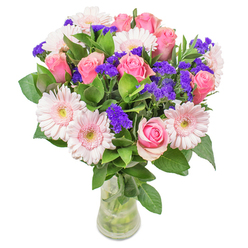 As I arrange these flowers in our Stanmore studio, I'm struck by the blend of delicate hues and lively textures swirling through the bouquet. Gentle, blush-toned gerberas bloom alongside classic pink roses, their soft petals merging in a dreamy, watercolour effect-an echo of early mornings in Stanmore Park, when the air is fresh and hope feels new. Deep purple statice adds a spirited punctuation, drawing the eye and infusing a zest that mirrors the cheerful gatherings on The Broadway. The dewy, fragrant leaves beneath create a cool, grounding base for the arrangement, enhancing both its freshness and the quiet sophistication felt throughout Stanmore's tree-lined avenues. Set in a simple glass vase, the pastel shades seem to glow, casting a warm invitation to come closer. Whether offered as a wish for speedy recovery or placed as a stylish centrepiece in a sun-drenched living room, this bouquet demonstrates both expert craftsmanship and the joy of sharing Stanmore's gentle spirit in floral form.