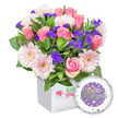 A vibrant celebration bouquet sits in a crisp white square presentation box, the kind you'd choose for a heartfelt congratulations in Stanmore. This bountiful arrangement centers soft pink roses, their petals unfurling from tight buds to open blush blossoms, exuding classic Romance and gentle fragrance. Interspersed with the roses are pastel pink gerbera daisies, their radiating petals edged in white and bright pale yellow centers lending a cheerful glow. Sprinkled throughout are clusters of vivid purple filler flowers-statice or limonium-providing striking contrast and a touch of jewel-like depth. Lush green foliage in varying textures and shades forms a natural, leafy frame that makes the blooms pop against the white box. To the lower right, a round foil engagement balloon floats, its surface a polished purplish panel framed by a white rim. Prominently displayed are the words You're Engaged! in silver lettering, with a golden O in You're, and tiny hearts scattered around the design. The group is completed with a subtle hint of sparkle and tiny silver stars, evoking celebration and romance. The overall presentation feels refined yet joyous-a perfect gift for a newly engaged couple, ready to brighten a Stanmore home, a desk at the station, or a doorstep during delivery across the area. Delivered with care from a Stanmore florist, this bouquet pairs elegance with a festive touch, making it an ideal choice for engagements, anniversaries, or bright moments to share with loved ones.