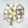 There is an air of effortless grace in this bouquet-an embodiment of the gentle tranquility that Stanmore is cherished for. Crisp white roses, blooming in full, layered spirals, form the elegant heart of the arrangement and speak of new beginnings and unspoken confidences. Pale, lavender-tinged statice thread through the roses, creating lacy, textured ribbons that soften and complement the purity of the surrounding blooms. Hints of green foliage peek from beneath, offering an echo of Stanmore's leafy avenues and expansive parks. Against a soft, white background, each flower glows in calming natural light, its velvety textures heightened and its colours radiant yet serene. Handcrafted with care by local Stanmore florists, this bouquet evokes comfort, hope, and remembrance-an ideal expression for milestones, comforting gestures, or thoughtful celebration, and a lasting testament to the power of delicate beauty and gentle optimism.