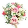 The photograph shows an elegant blush pink hatbox arrangement set against a pristinely white background, captured from a slightly overhead angle so that the full curve of the bouquet is clearly visible. The hatbox itself is a gentle, powdery pink with a slim, deeper rose-pink satin ribbon wrapped tidily around it, the sheen of the ribbon adding a touch of quiet luxury. A small cream tag hangs from the ribbon, its wording turned mostly away from the lens, hinting at a boutique florist's mark that could easily belong to a trusted Stanmore flower shop. Rising from this base is a lush dome of blooms and foliage in soft pink, white, and green, creating a mood of romantic calm that would feel at home in any Stanmore living room, whether overlooking Canons Park or a quieter residential lane. Several light pink roses immediately draw the eye, their petals spiralling out in velvety layers that move from slightly deeper blush at the centre to pale pink at the edges. Around them cluster white daisy-like chrysanthemums, their crisp petals and bright green centres lending a clean, uplifting contrast and a sense of cheerful brightness. Threaded delicately between these are white alstroemeria, whose slender petals are decorated with fine purplish-red streaks and speckles, adding intricate detail and an almost hand-painted quality. The arrangement is framed by a variety of greenery: rounded eucalyptus leaves in silvery green create a cool, textural halo, while darker green, strappy leaves weave among the stems, giving depth and a soft sense of movement. Tiny clusters of reddish-brown buds or berries are tucked in thoughtfully, their warm tones gently echoing the ribbon and enhancing the natural, garden-inspired aesthetic. The overall impression is of a carefully crafted gift-ideal for birthdays, anniversaries, or simple gestures of care delivered across Stanmore, from homes near The Broadway to peaceful streets close to Stanmore Country Park.