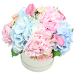 From within a pristine white round hatbox, Flowers Stanmore presents a lush, abundant bouquet that speaks of refined celebration. The dome overflows with a harmonious blend of soft pastel pinks and powdery blues, its heart anchored by large pink peonies whose plush petals invite a touch. Dense clusters of light baby blue hydrangeas drift through like fluffy clouds, lending a cool, airy breath to the arrangement. Interspersed among the main blooms are delicate pale pink spray roses, their buds tightly furled, and two trumpet-shaped calla lilies in a deeper, rose pink-one near the top-left and another peeking from the lower-right edge. Subtle touches of foliage-the hydrangea leaves and the silvery sheen of dusty miller-frame the blossoms and add depth. The bouquet is crafted into a full, rounded dome, a look of opulent ease that feels timeless. Set against a pure white background, this elegant hatbox reads as a sophisticated gift for birthdays, anniversaries, baby showers, or gender reveals, a gentle expression of romance and refined charm.
In and around Stanmore, this design travels with care to Canons Park, Edgware, and the surrounding Harrow communities. Flowers Stanmore offers reliable same-day delivery across the local area, ensuring this pastel dream can brighten a living room, a doorway, or a celebratory table at short notice. The arrangement balances grandeur with intimacy: peonies for lush luxury, hydrangeas for softness, spray roses for tender movement, and the calla lilies for architectural height. It suits a formal centerpiece or a warm, heartfelt gift for someone special, from a birthday to a new arrival, to a moment when you simply want to convey quiet celebration. Crafted with steady hands and an eye for harmony, this hatbox bouquet endures as a graceful symbol of affection in Stanmore's charming streets.