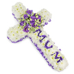 A tender, cross-shaped funeral tribute crafted from a dense carpet of pristine white chrysanthemum heads, presented against a clean white background so every texture and contour reads clearly. Each chrysanthemum is closely set to create a soft, pillowy surface that catches cool studio light and suggests quiet purity. The cross is edged throughout with a ruffled purple satin ribbon whose gentle sheen frames the shape with solemn elegance; the ribbon's pleats throw soft, shadowed lines that heighten the arrangement's sculptural form. Running down the vertical arm, the name MUM is hand-formed from small, rich purple blooms-likely miniature eustoma or spray chrysanthemums-each letter bold against the white field and instantly personal. At the centre, where the arms meet, a lush focal spray gathers attention: deep violet and lavender roses nestle with purple lisianthus, their velvety petals layered and slightly open, surrounded by variegated green foliage with pale margins that add lightness and depth. A few small green berries are tucked in for texture, and there is a faint powdery scent of fresh blooms like early spring rain. The overall palette of white and varying purples-from soft lilac to brooding violet-creates an atmosphere of reverence, consolation, and quiet dignity. As a local florist familiar with Stanmore mornings near Stanmore Broadway and Canons Park, I imagine this tribute placed near a chapel entrance or beside a graveside, offering a composed, heartfelt expression of remembrance and enduring love for family and friends gathered to say farewell.