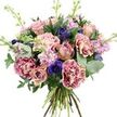 In the photograph, a sumptuous hand-tied bouquet stands out crisply against a plain white background, its rounded shape and layered textures immediately drawing the eye, as if it has just been set down in a Stanmore living room filled with light. At the core of the design, generous roses and rose-like flowers open in graceful spirals, their petals tinted in dusty pink, soft mauve, and warm peach tones. Some are fully blossomed with velvety, open faces, while others remain more tightly furled, adding variation and a feeling of gentle unfolding. Surrounding these central blooms are rich, ruffled carnations whose fringed petals create luxurious volume. Their colouring shifts subtly from vibrant magenta and plum shades along the outer edges to creamy, blush-pink centres, forming a refined, two-tone pattern that adds interest without overpowering the overall softness. Punctuating this pastel harmony are deep indigo and violet-blue anemones, each displaying a dark eye that introduces a bold focal point and lends a modern, stylish edge. Between the larger heads, slender spikes of lavender and pale pink stock stretch upward, their many small florets densely packed along the stems, offering a feathery, cloud-like texture and the suggestion of a light, comforting fragrance. The bouquet is framed by a collar of fresh greenery, including cool, silvery eucalyptus rounds and deeper green leaves that recall the layered foliage of Stanmore's gardens and tree-lined streets. At the bottom, the natural stems are neatly gathered and left visible, confirming the hand-tied craftsmanship. Gentle, even lighting reveals the interplay of colour, shadow, and petal detail, making this arrangement ideal for sending love, congratulations, or warm wishes to homes and celebrations across Stanmore, from the Broadway to the quieter residential cul-de-sacs.